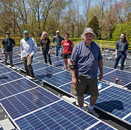 Rocky Ackroyd '83 of GreenSun Solar works with students to install a solar array.