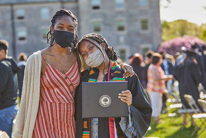A graduate poses with a supporter.