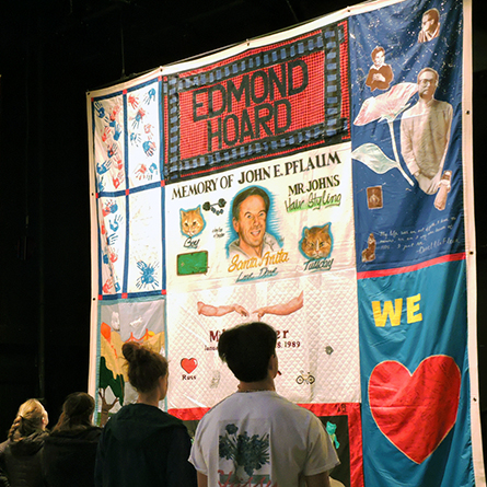 Students view the AIDS Memorial Quilt panels on display in Conn's Tansill Theater.