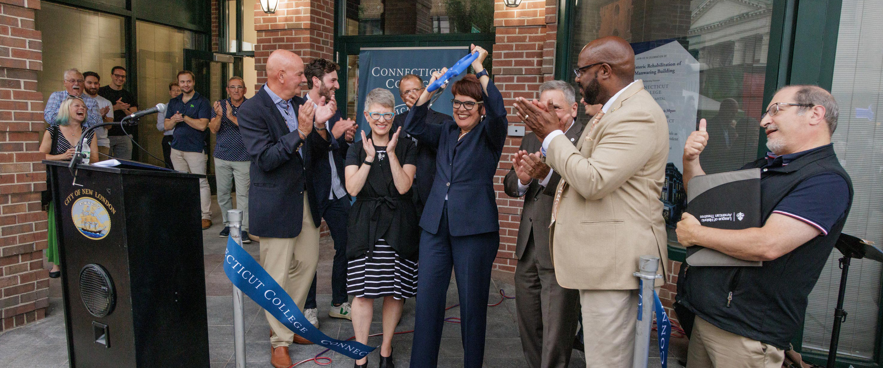 President Katherine Bergeron snips a ceremonial ribbon to open the newly transformed historic Manwaring Building.