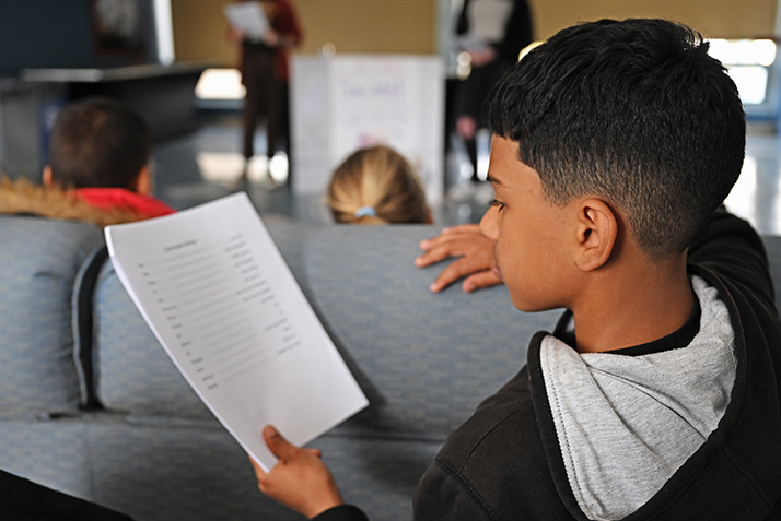 J.J. Figueroa, 11, follows along on a Latin vocabulary sheet during a presentation from Caleb Butler ’26 and Melanie Rollins ’25 during World Languages Day.