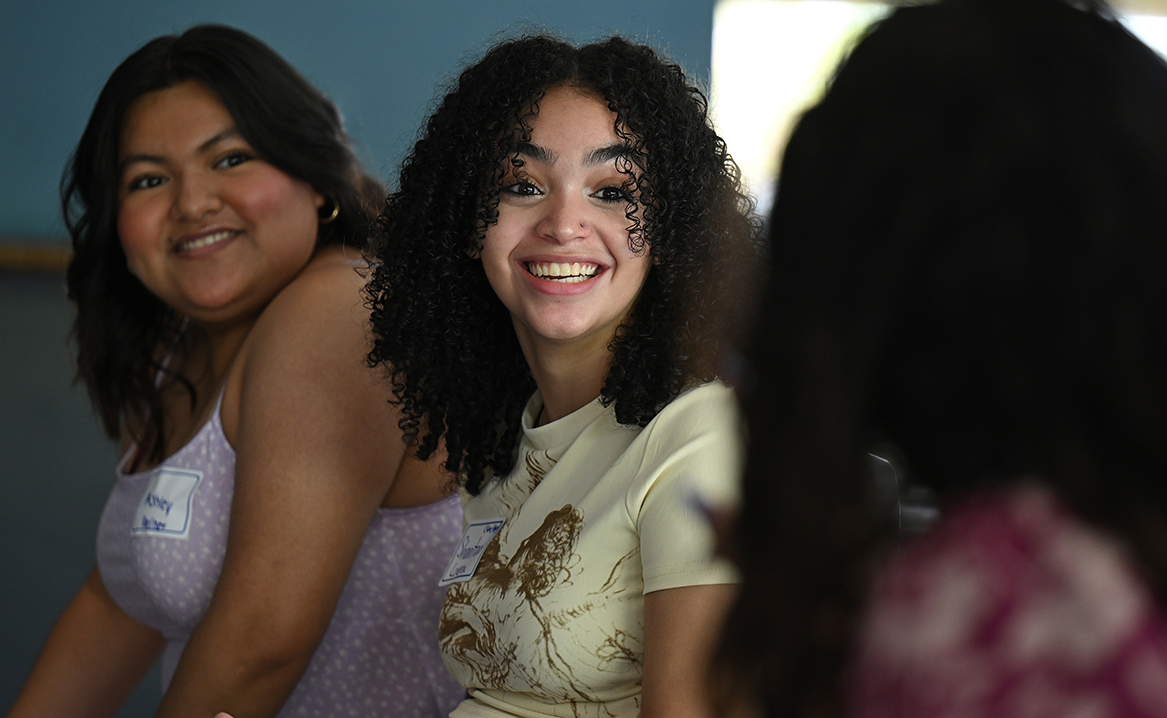 Summer Civic Leaders Ashley Perez Diaz ’25, left, and Shantaal Lovera ’25 talk with a guest at the final presentations at Cro’s Nest