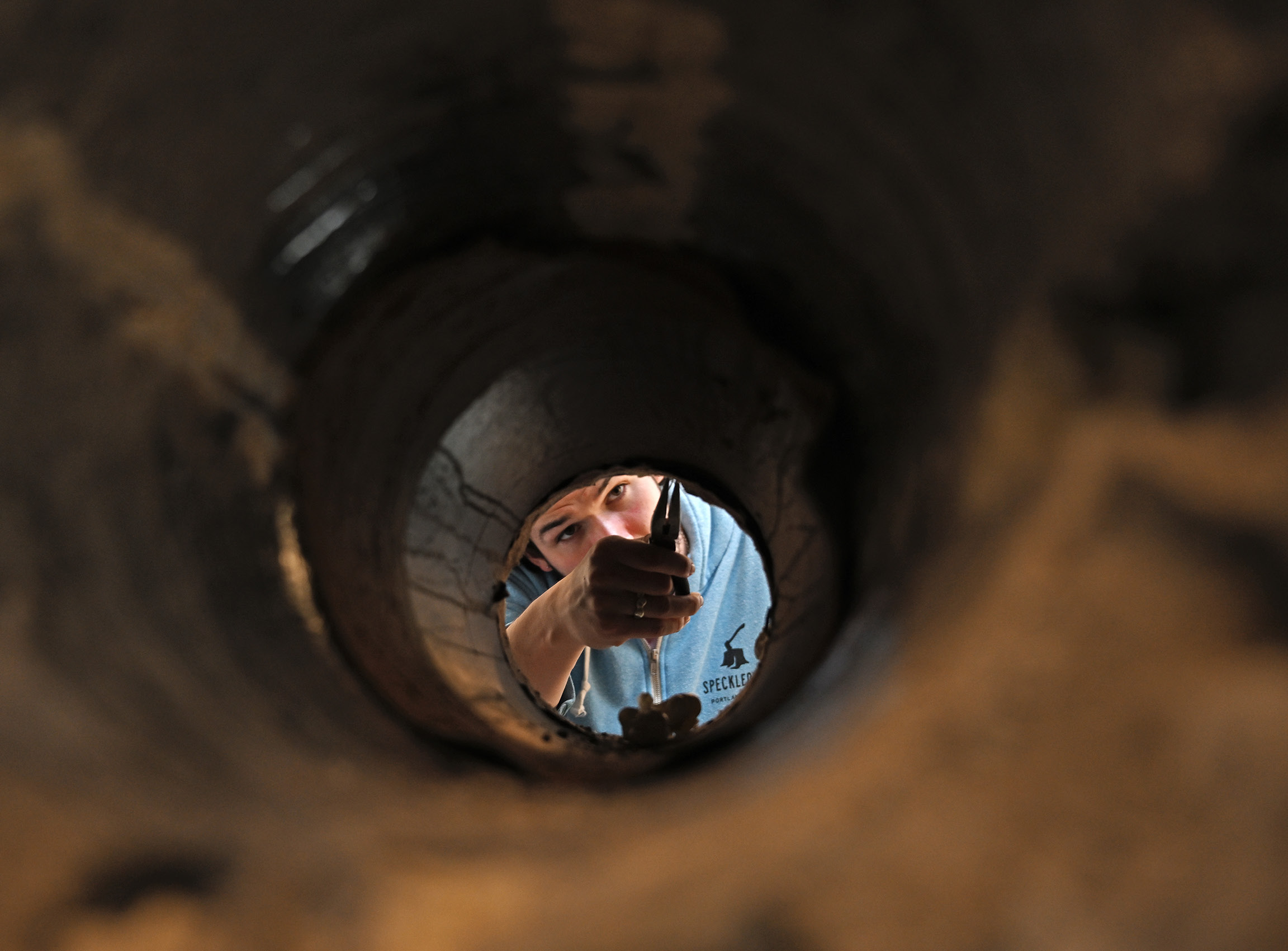 Student looking through a piece of sculpture