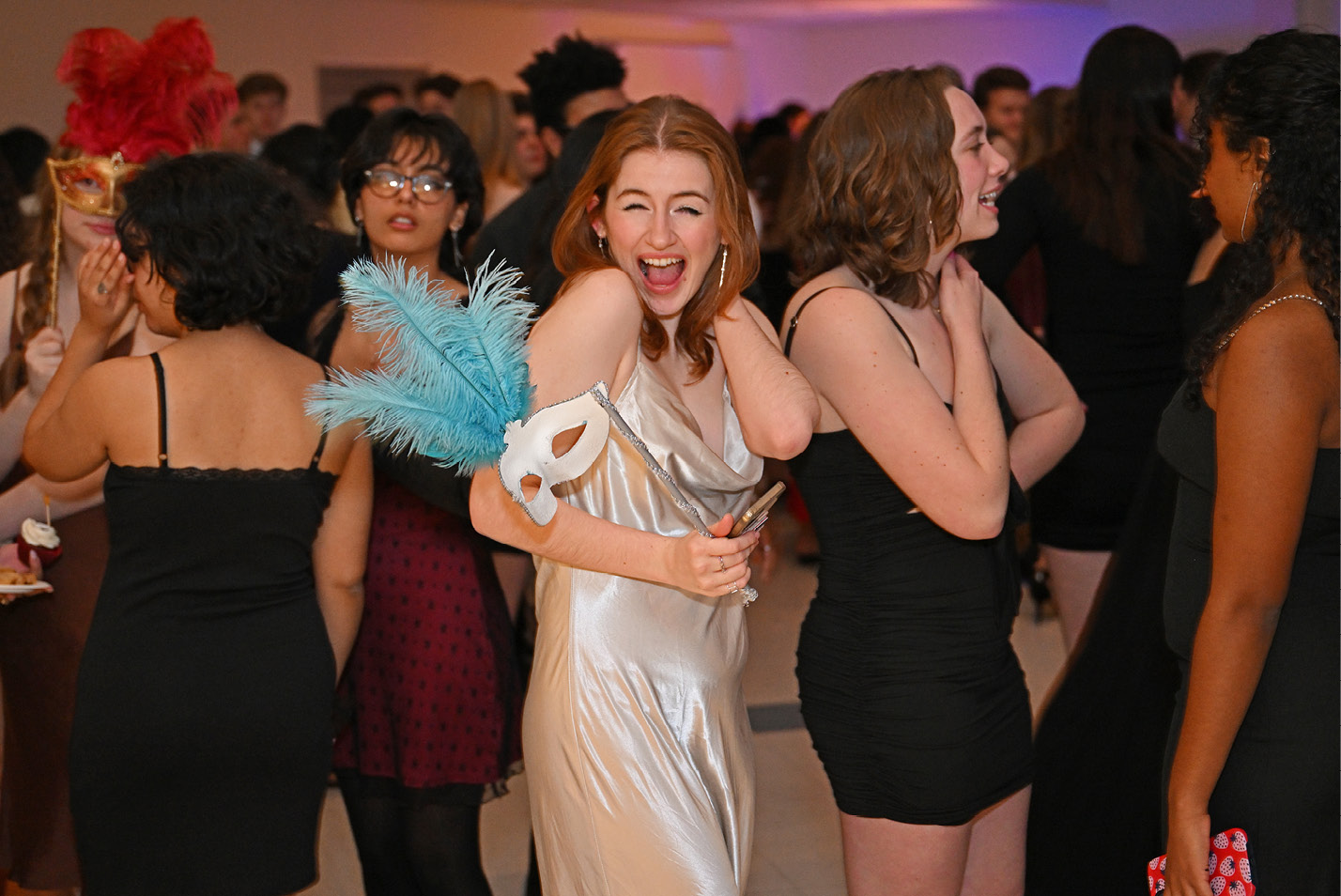 A student smiles at the winter formal masquerade ball sponsored by the Student Activities Council in the 1962 Room.