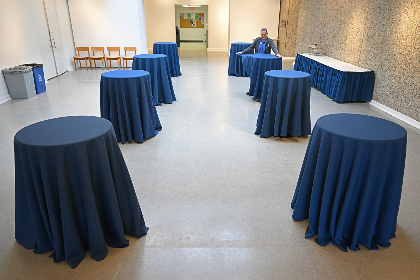 Catering assistant Caroline Ball sets up tables in the Joanne Toor Cummings Gallery.