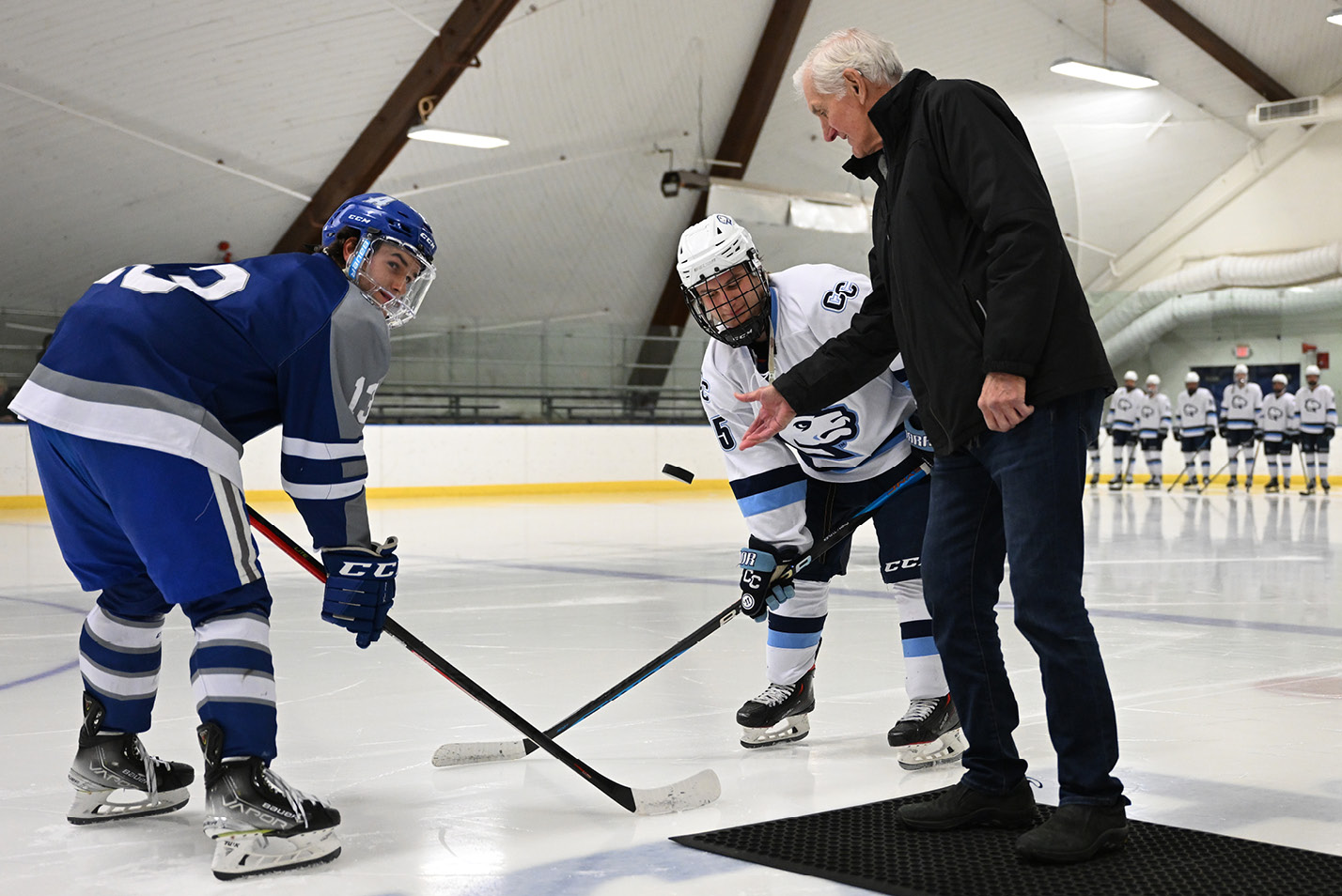 Former Camels men’s ice hockey coach Doug Roberts drops the puck on the ice.