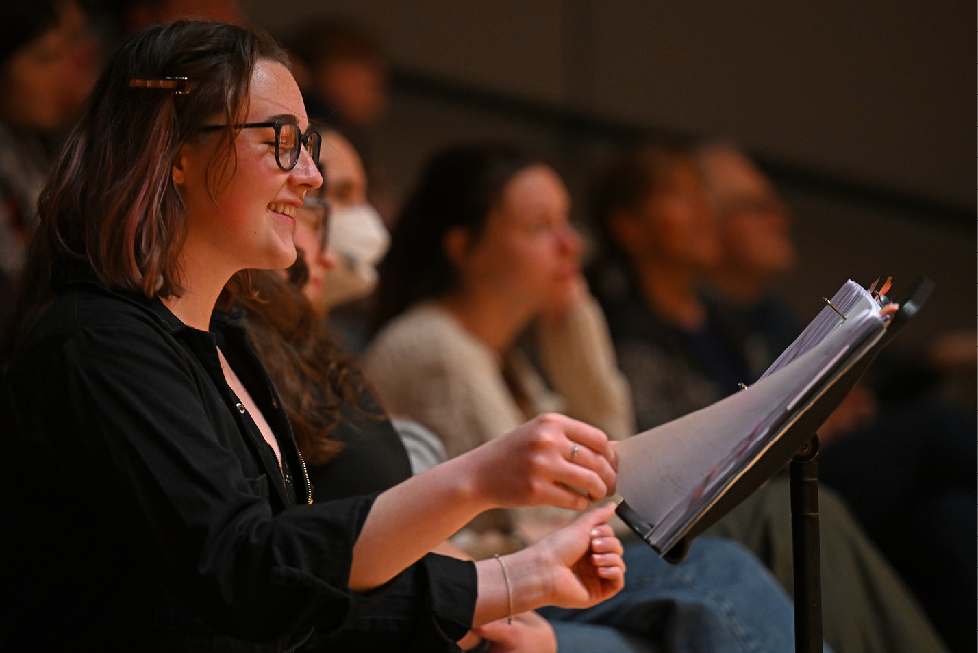 A student directs the singers during 