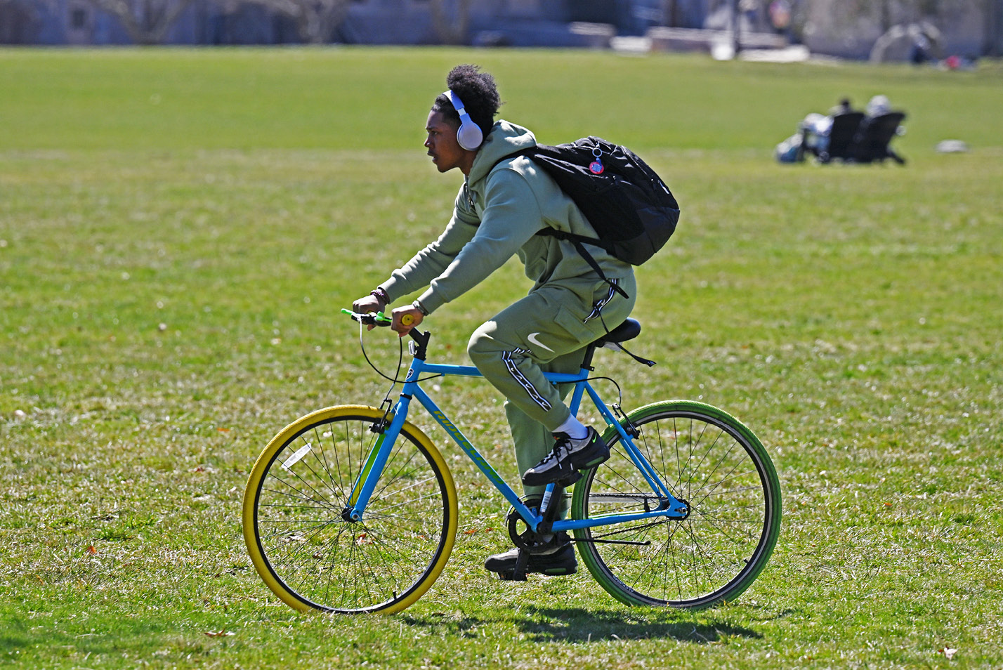 Joel Embray ’25 rides his bicycle across Tempel Green.