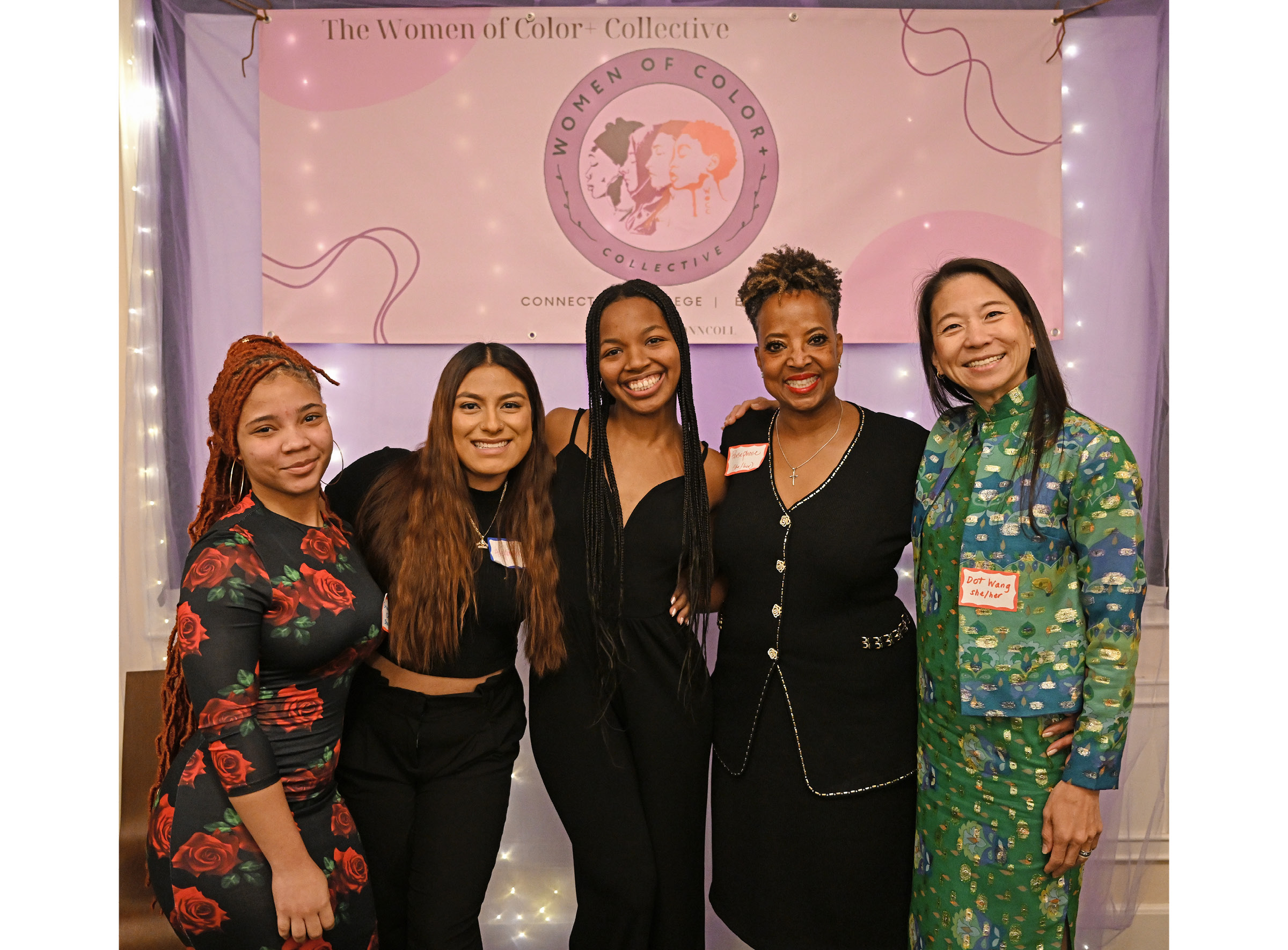 Five women standing in front of a banner