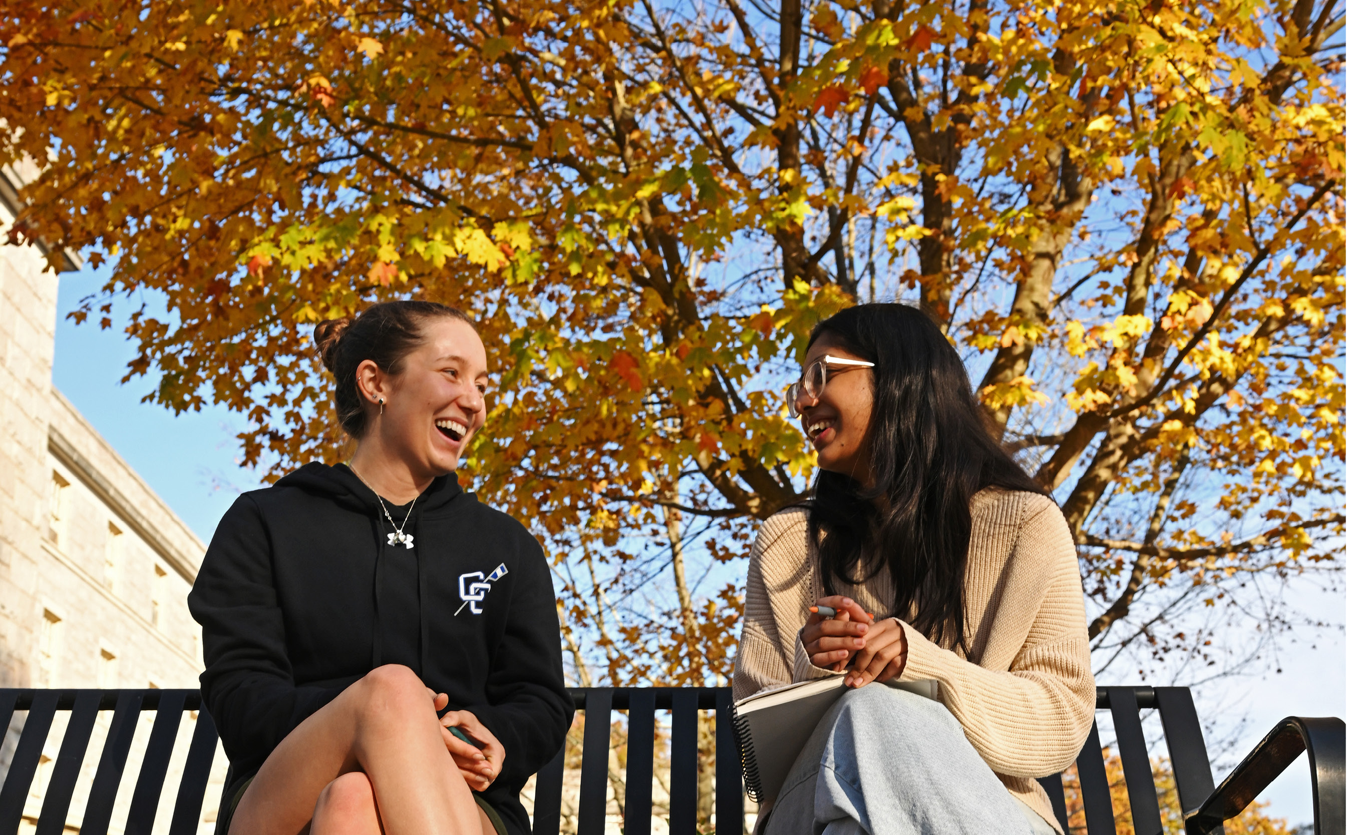 Two students sitting on a bench