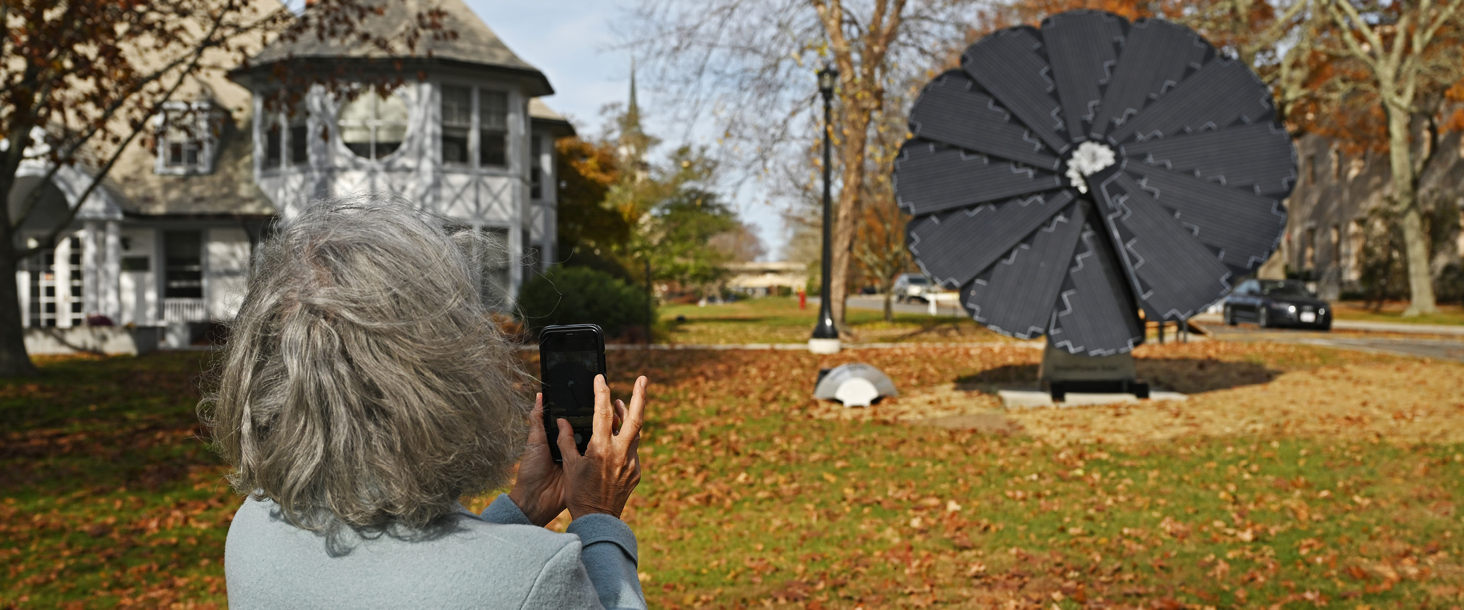Woman taking a picture of a Solar Flower Being Setup.