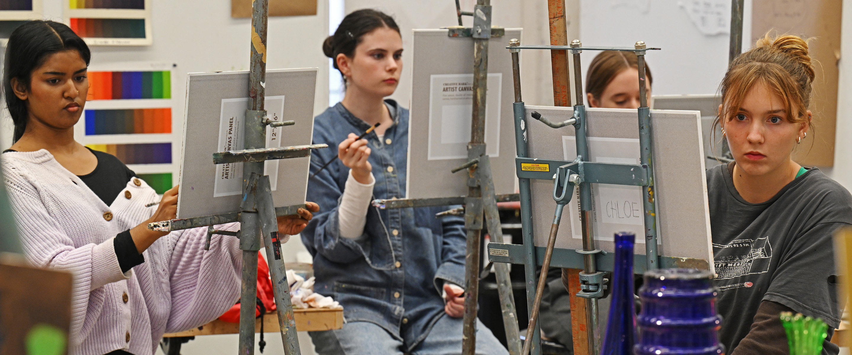 Students painting at easels