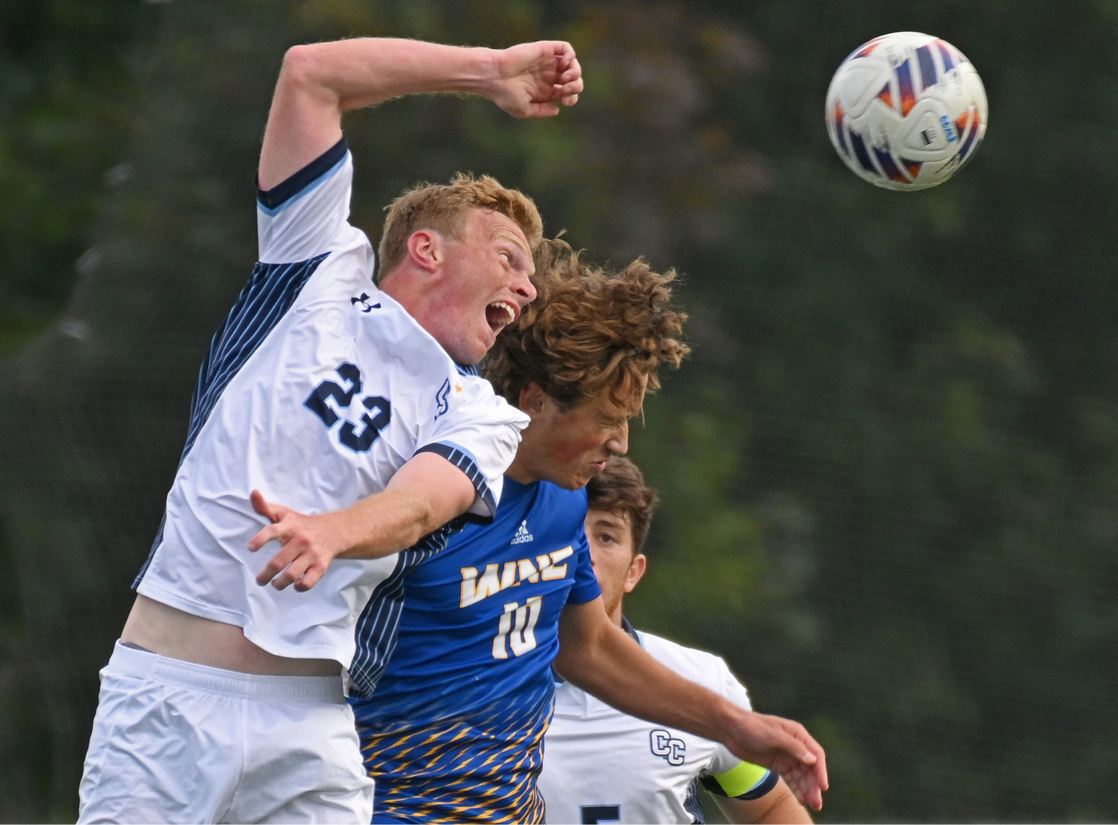 Men's soccer player heads ball