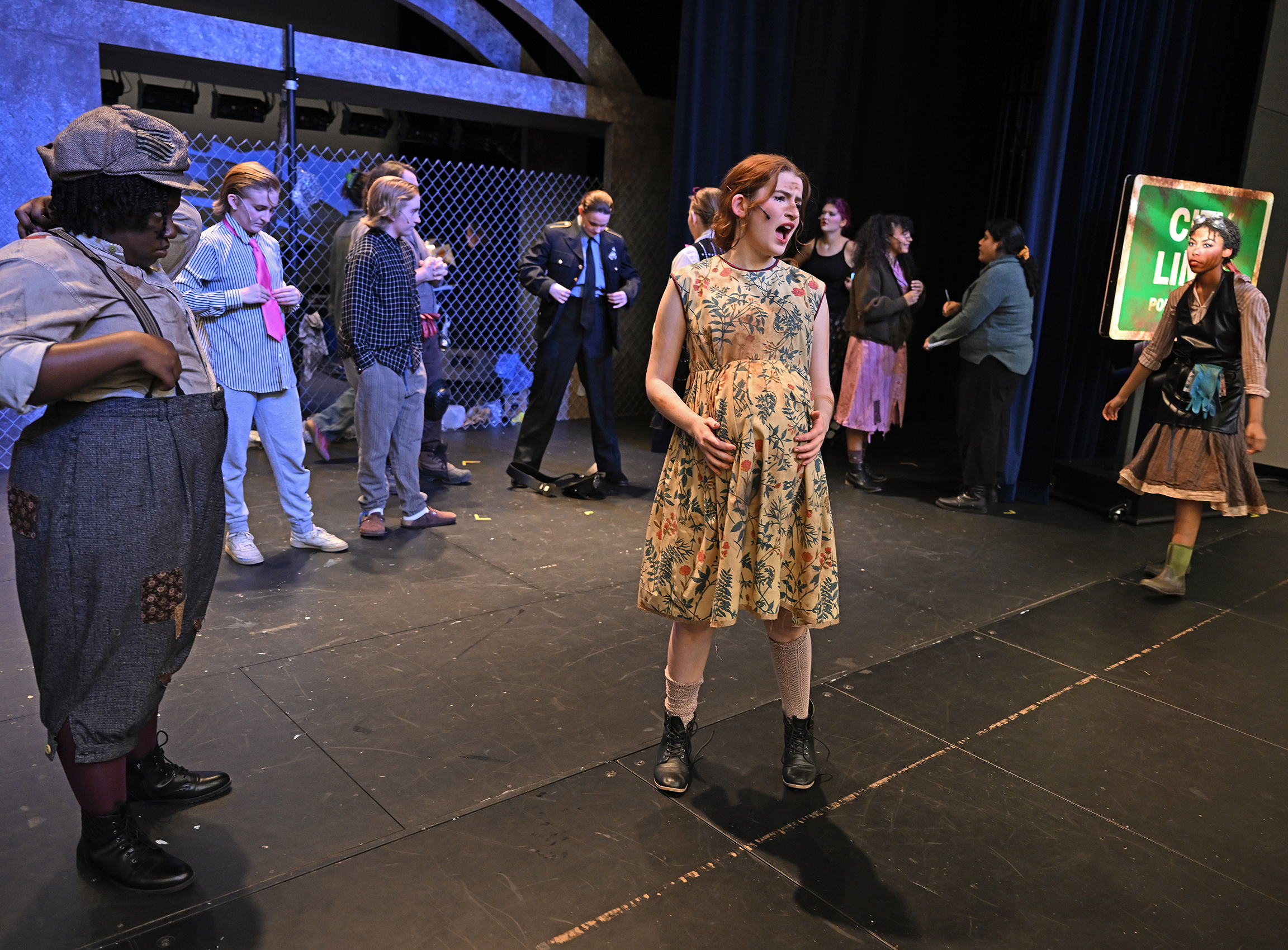 an actor sings on stage