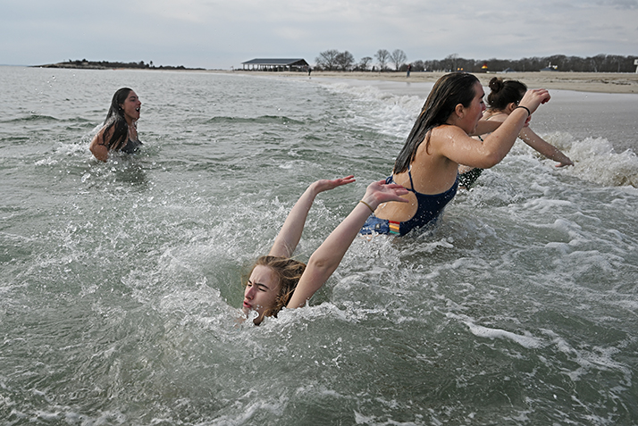 A student disappears into the cold water at a polar plunge