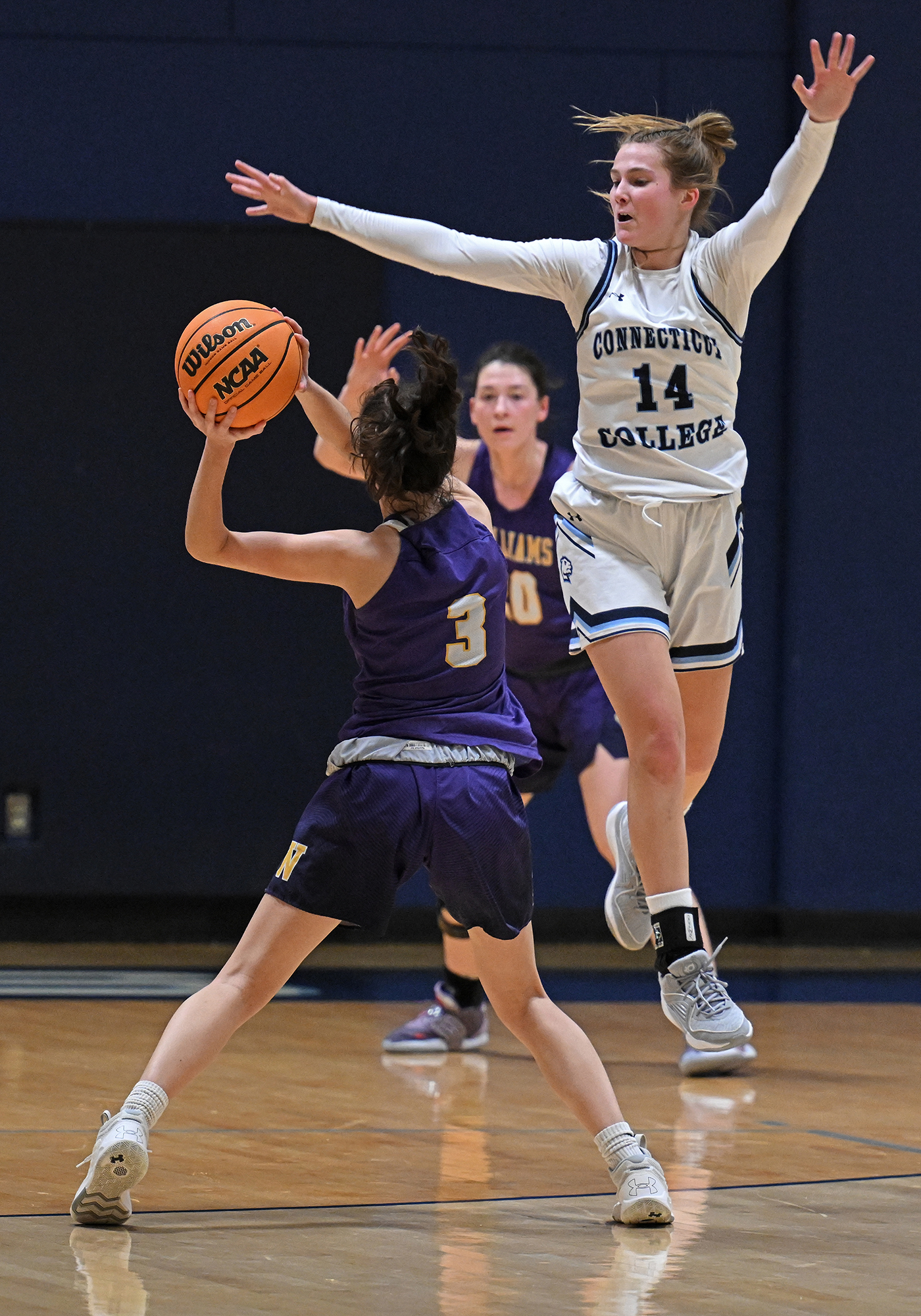 basketball player leaps on defense
