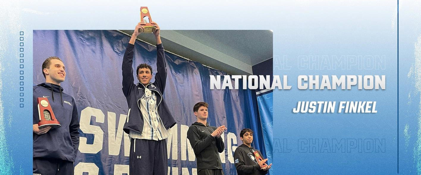 Justin Finkel ’25 holds an NCAA trophy at the men