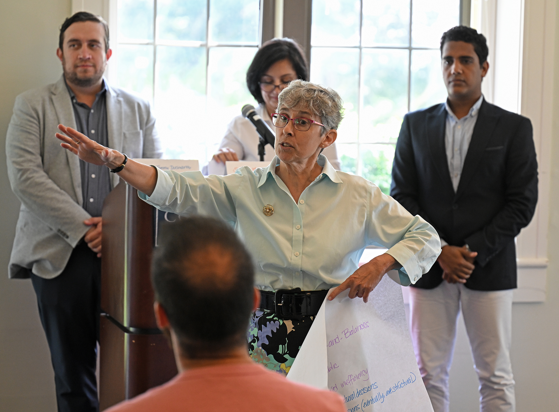 A professor gestures while making a point