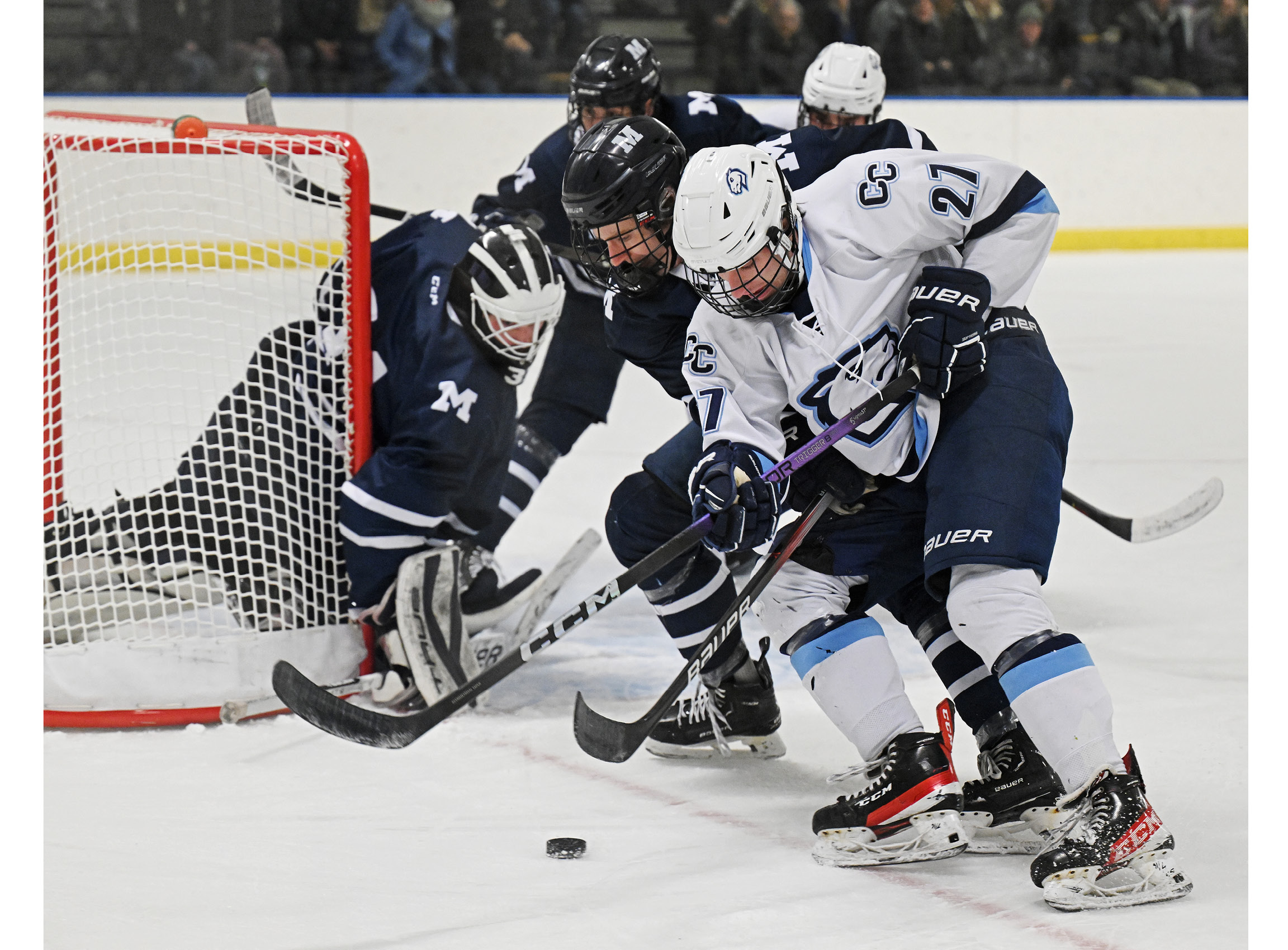 Men’s hockey forward Quinn Kennedy (27) '27 carries the puck to the goal vs. Middlebury in late January.