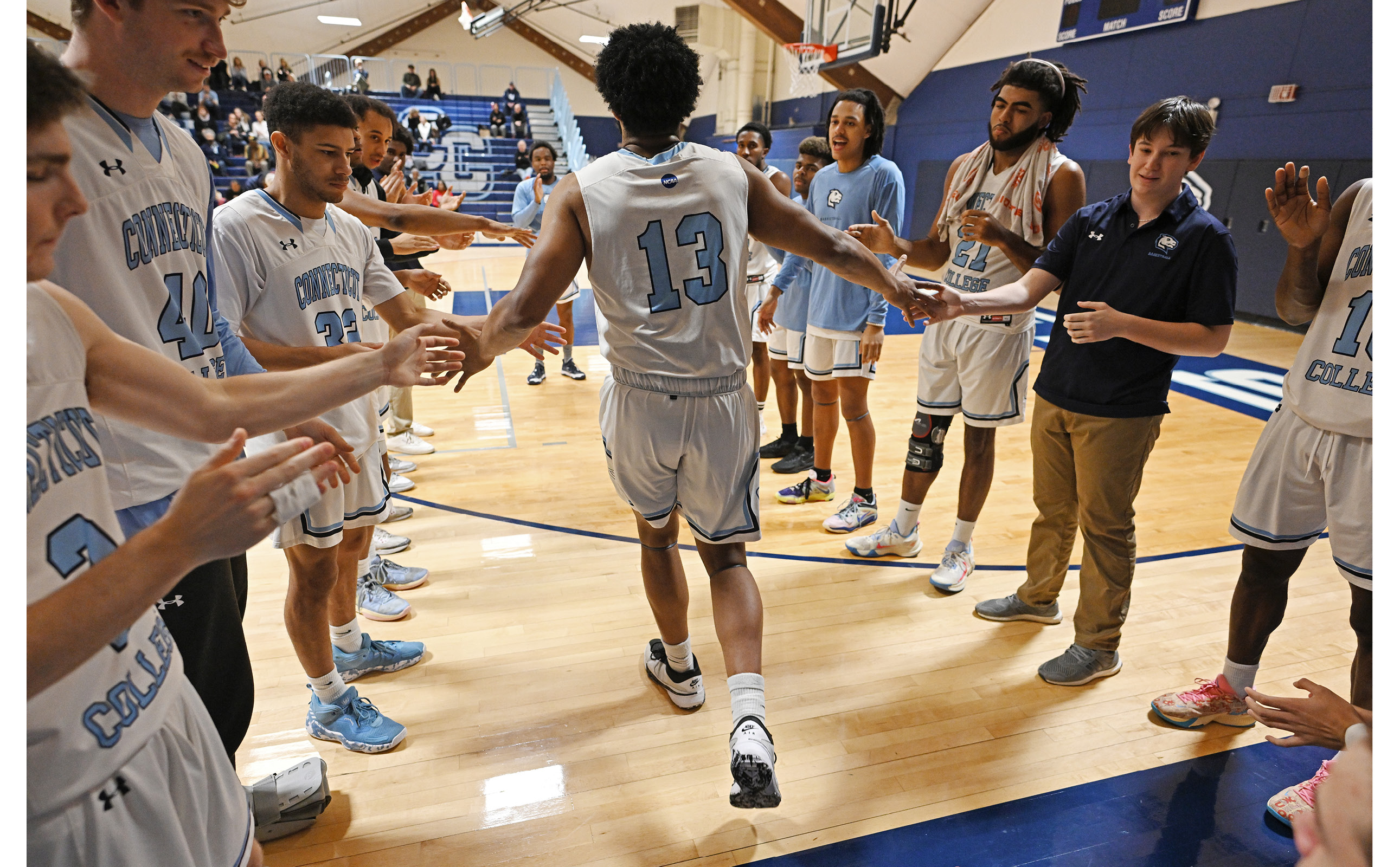 Men's basketball forward David Murray '24 high-fives the lineup v. Wesleyan in NESCAC action Sunday, January 14, 2024