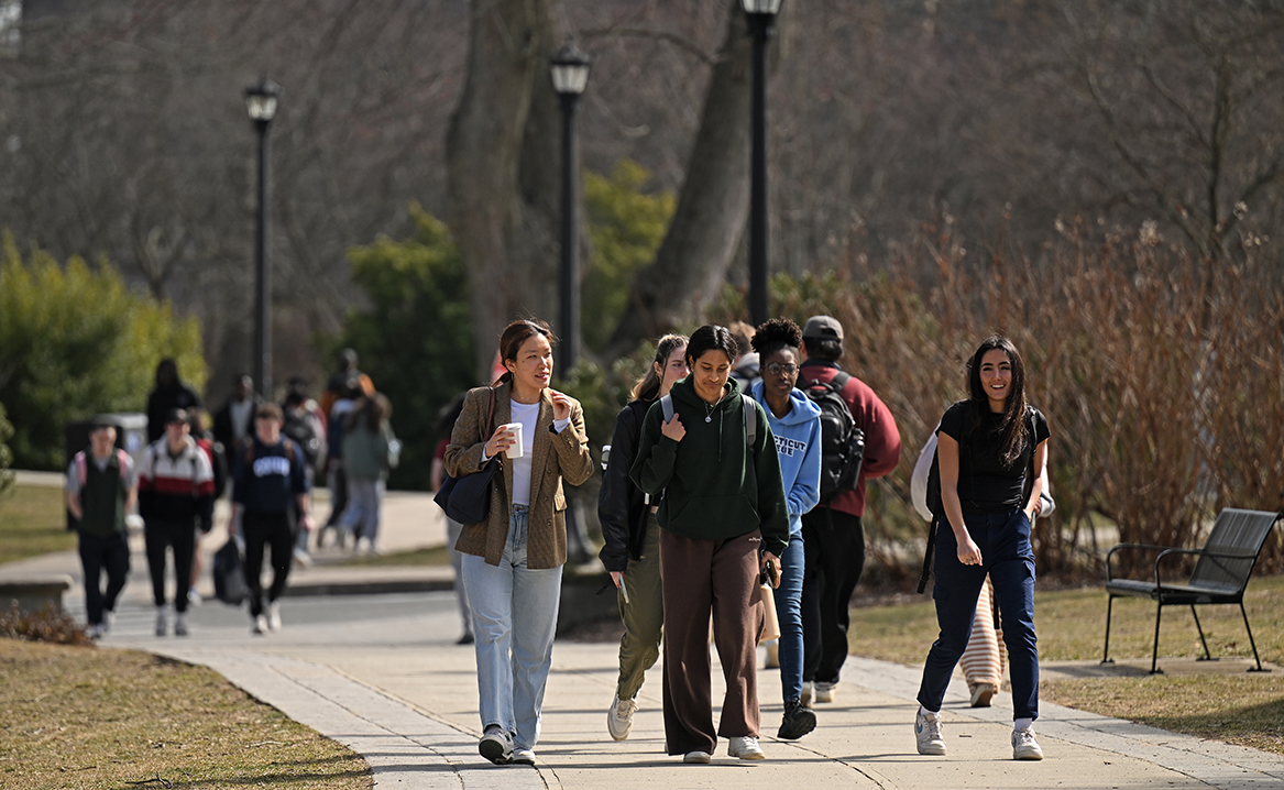 students walk across a flowering campus
