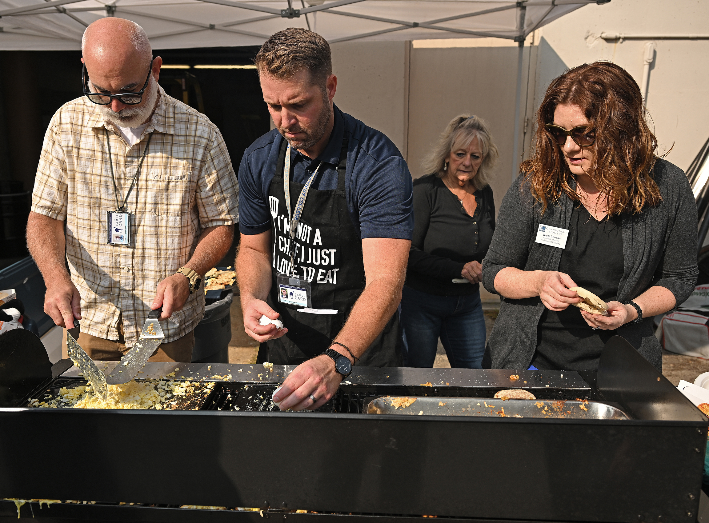Administrators cook breakfast on the griddle.