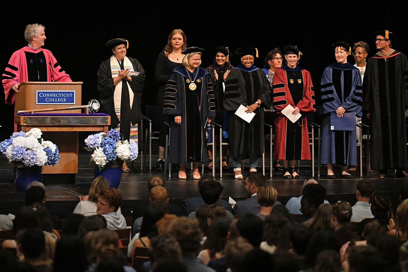 Faculty and administrators stand on stage during the 111th Convocation
