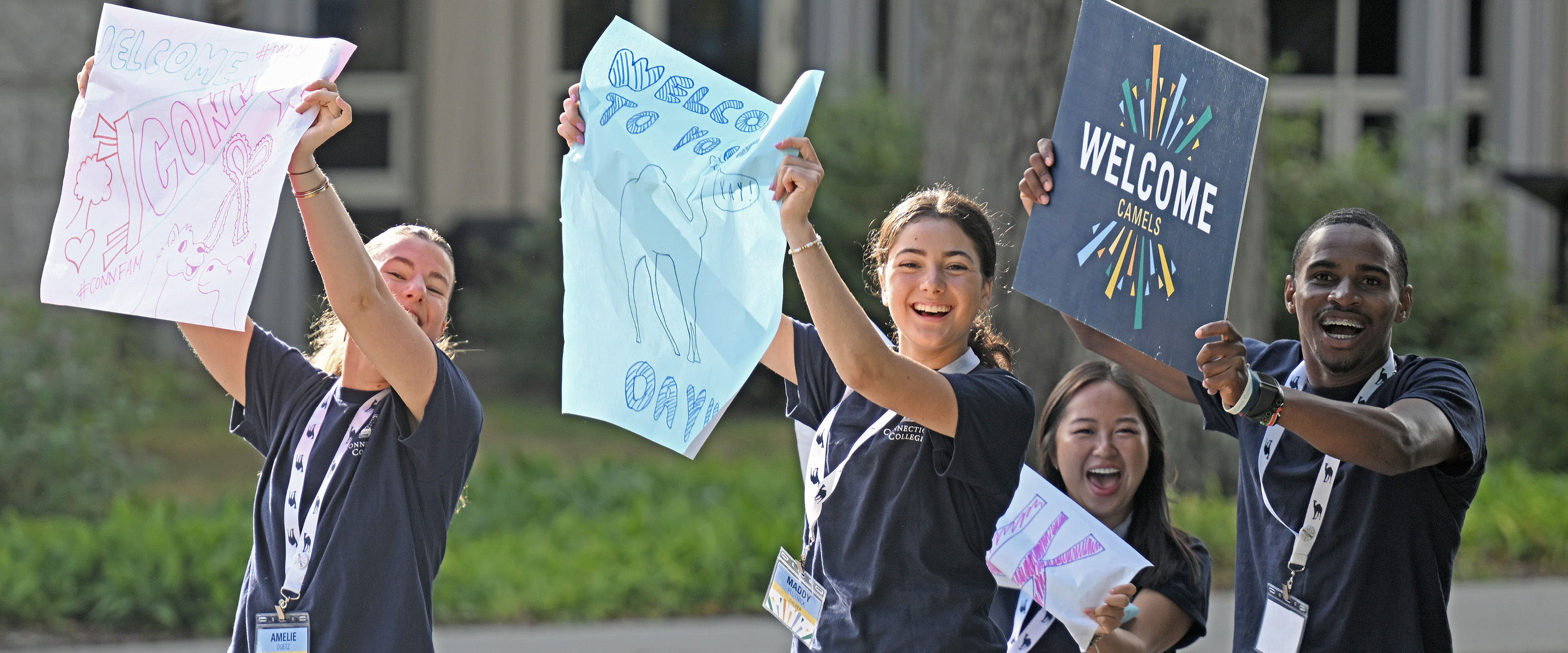 Student leaders cheer as new students arrive on campus.