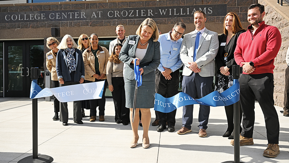President Andrea E. Chapdelaine cuts the ribbon in front of a newly renovated Cro.