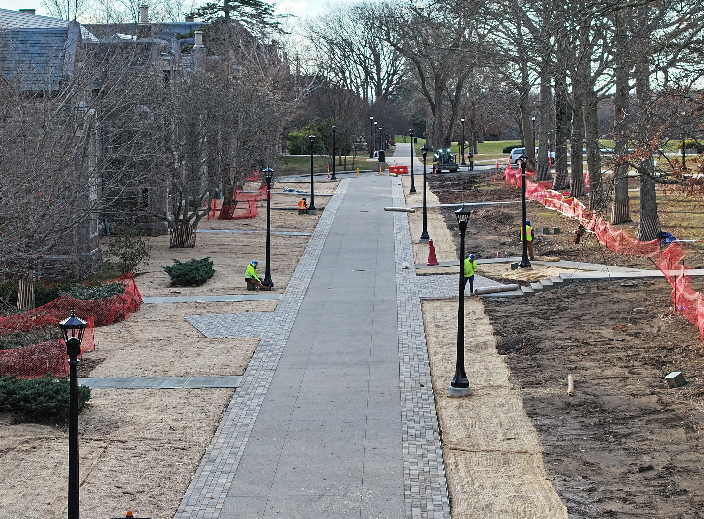 Workers prepare a newly constructed pedestrian promenade to open to traffic.