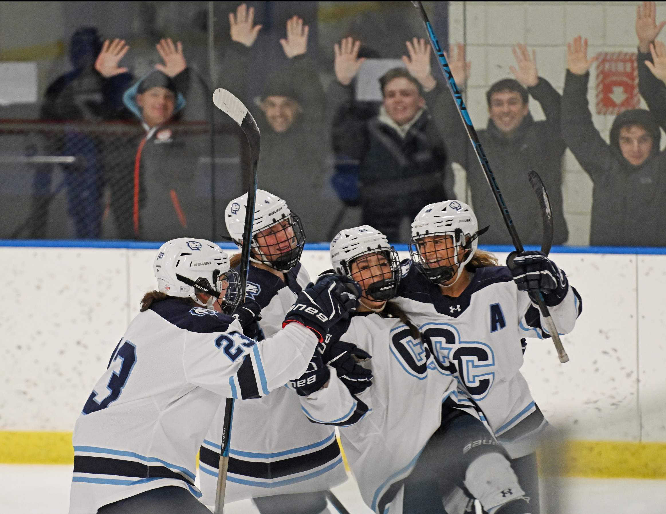 Connecticut College women’s hockey defender Kayla Kasprzak (23) '25, forward Alana Burm (4) '26, forward Claire Sammons (18) '25. And defender Caitlin Pierce (24) '28 celebrate Sammons’ game-winner v. Manhattanville University Tuesday, January 21, 2025 at Dayton Arena