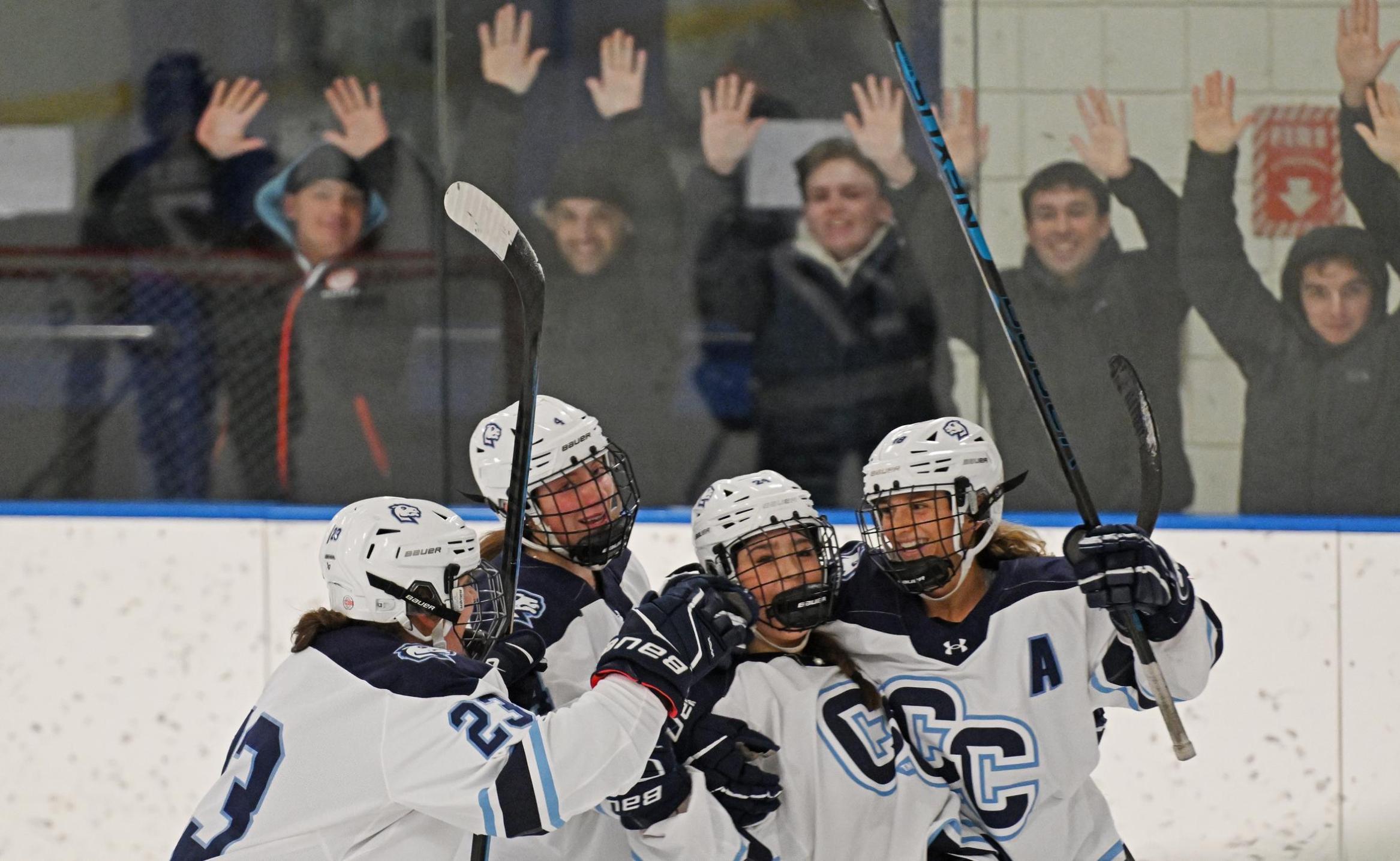 Connecticut College women’s hockey defender Kayla Kasprzak (23) '25, forward Alana Burm (4) '26, forward Claire Sammons (18) '25. And defender Caitlin Pierce (24) '28 celebrate Sammons’ game-winner v. Manhattanville University Tuesday, January 21, 2025 at Dayton Arena