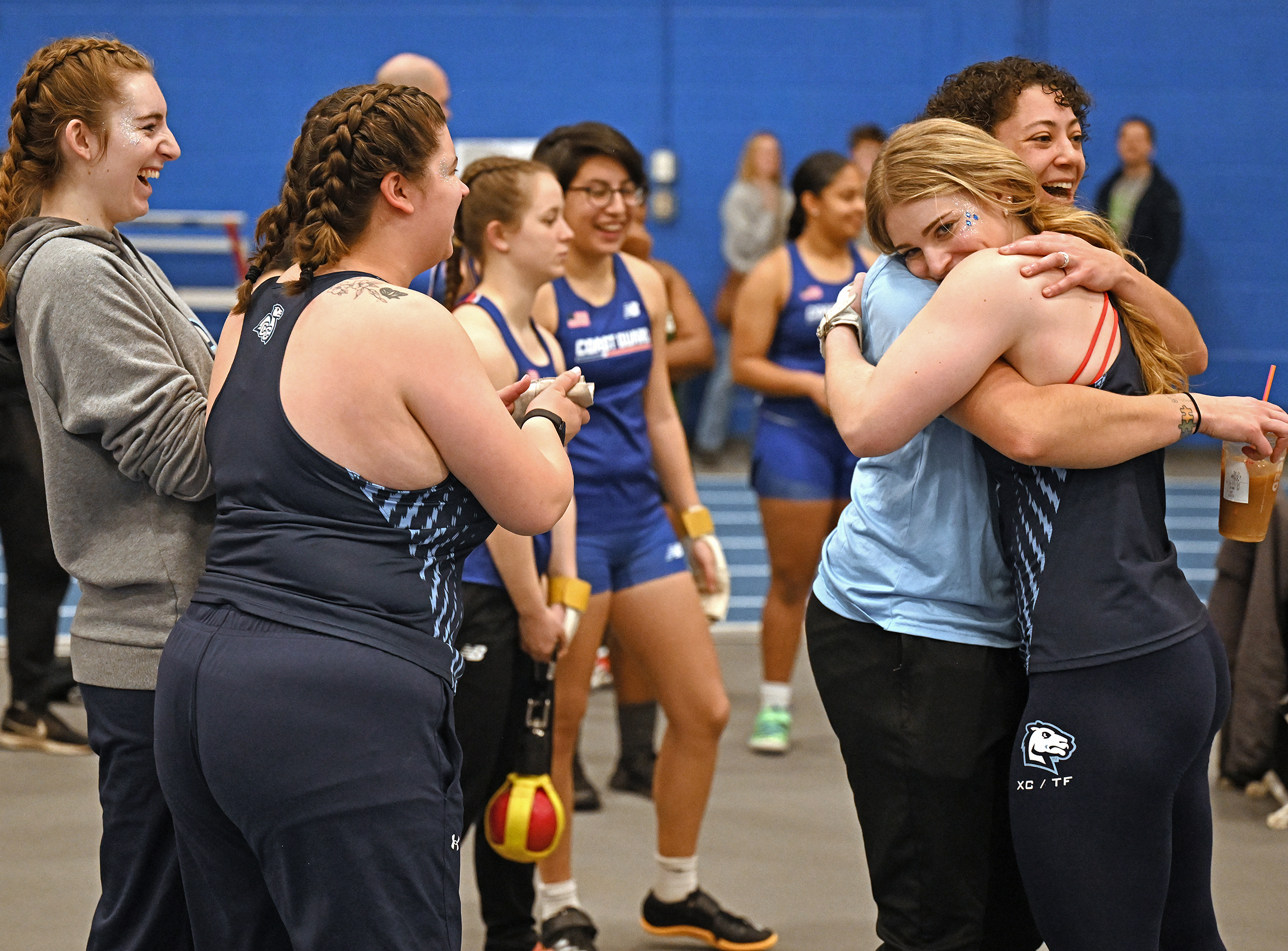 Connecticut College women’s hockey defender Kayla Kasprzak (23) '25, forward Alana Burm (4) '26, forward Claire Sammons (18) '25. And defender Caitlin Pierce (24) '28 celebrate Sammons’ game-winner v. Manhattanville University Tuesday, January 21, 2025 at Dayton Arena