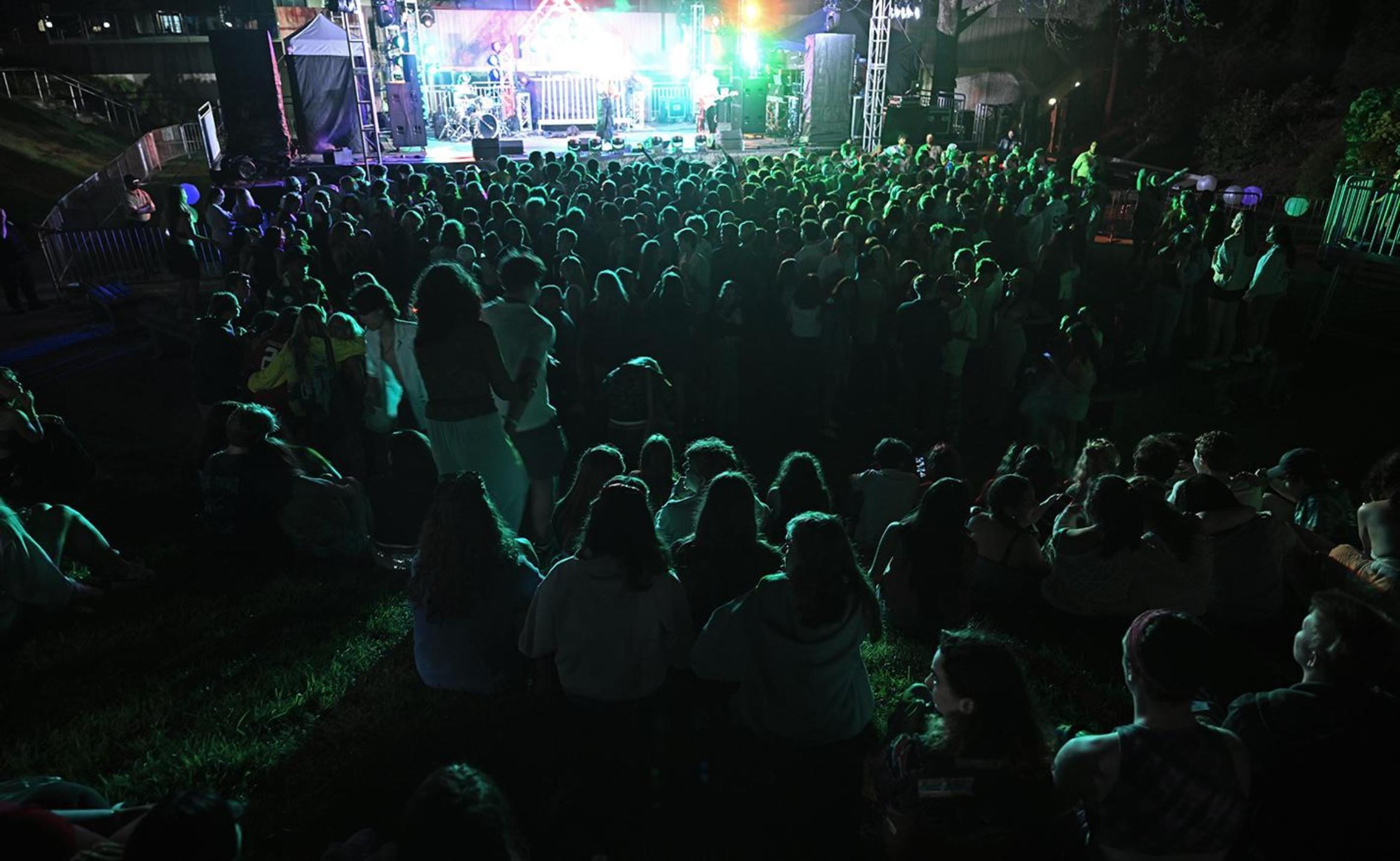 A sea of students illuminated by the Floralia stage.