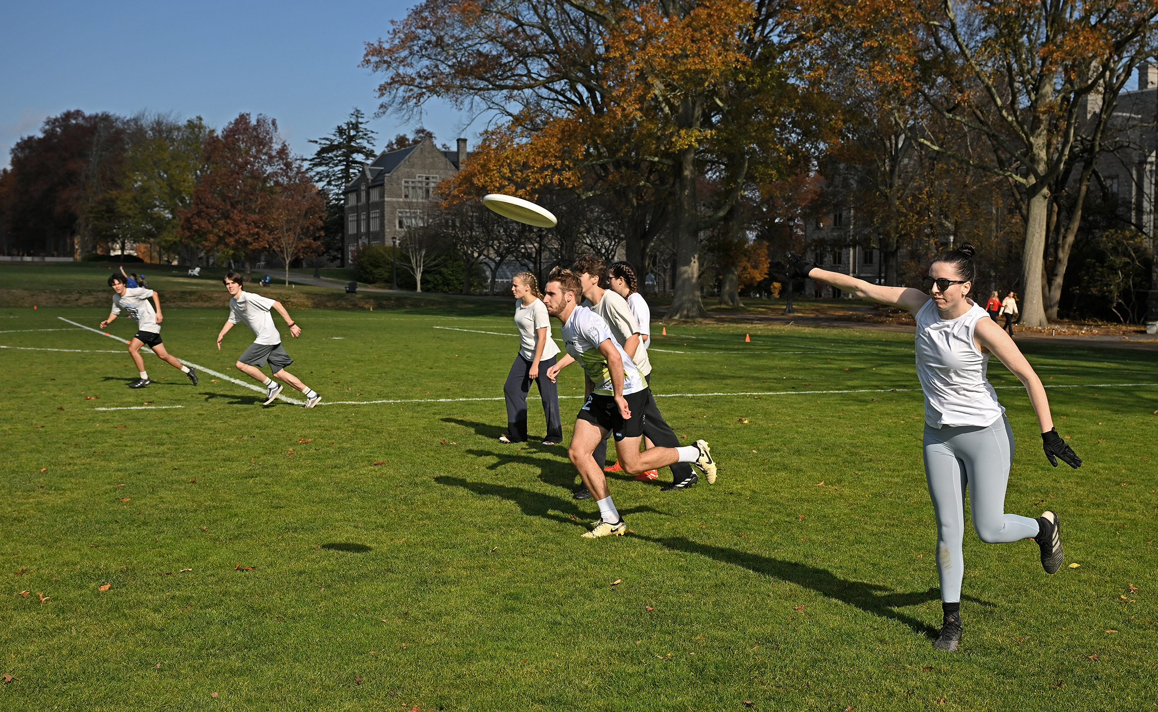 College ultimate disk players start play by throwing the disc downfield to their opponents.