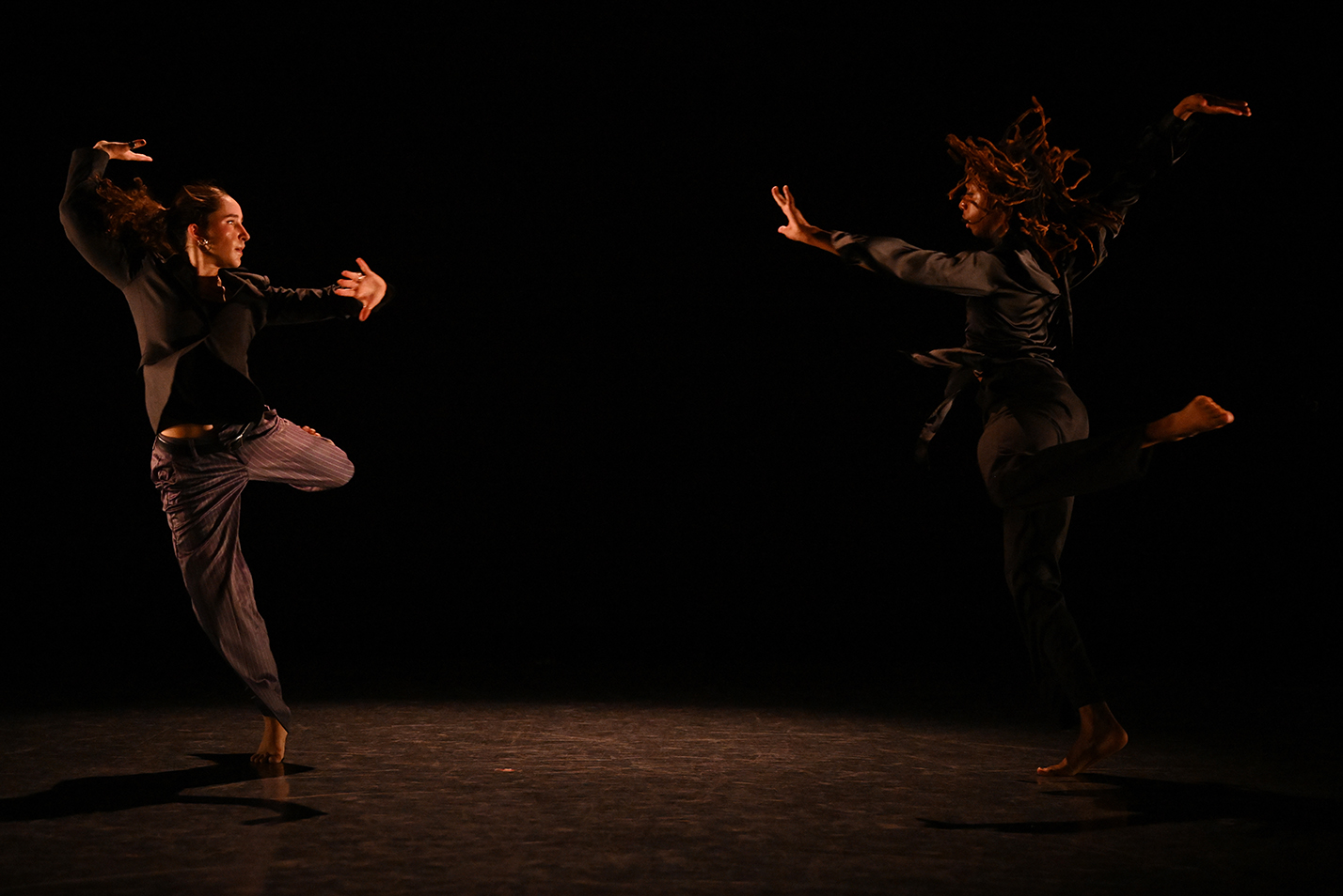 Student dancers perform modern dance in a dance studio.