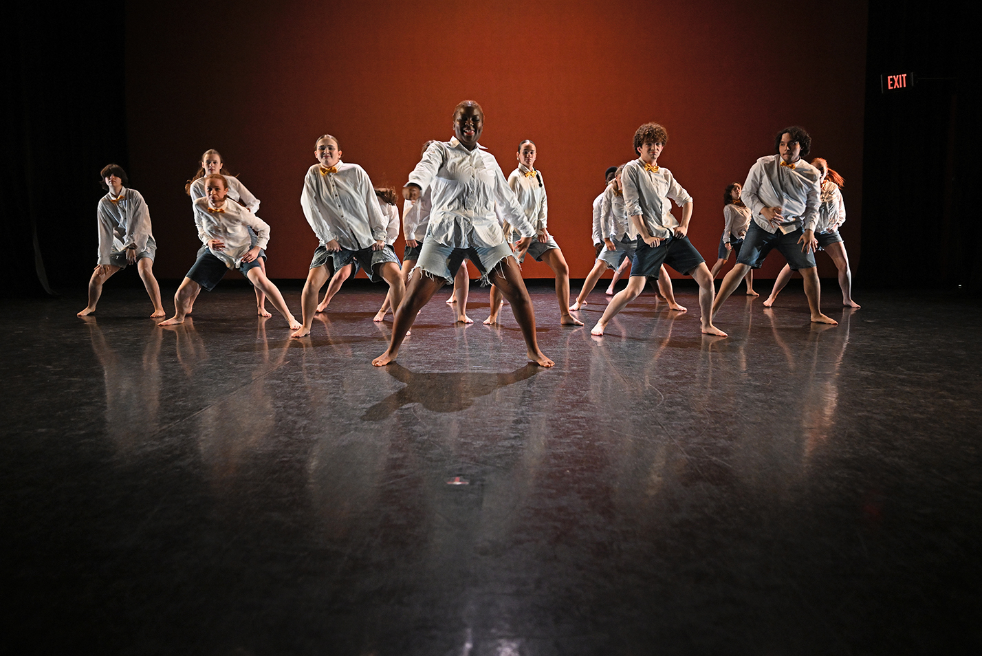 Student dancers perform modern dance in a dance studio.