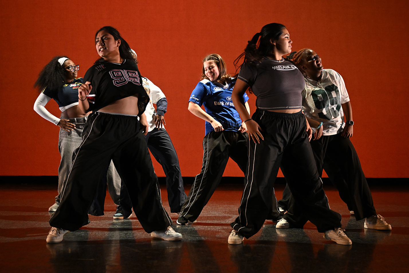 Student dancers perform modern dance in a dance studio.