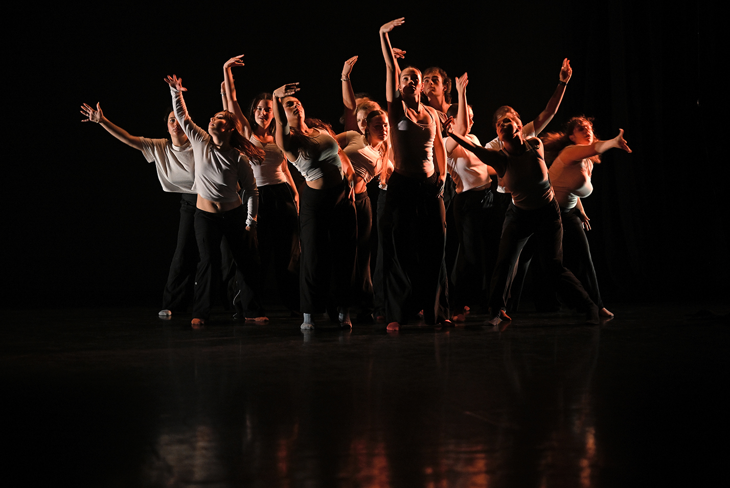 Student dancers perform modern dance in a dance studio.