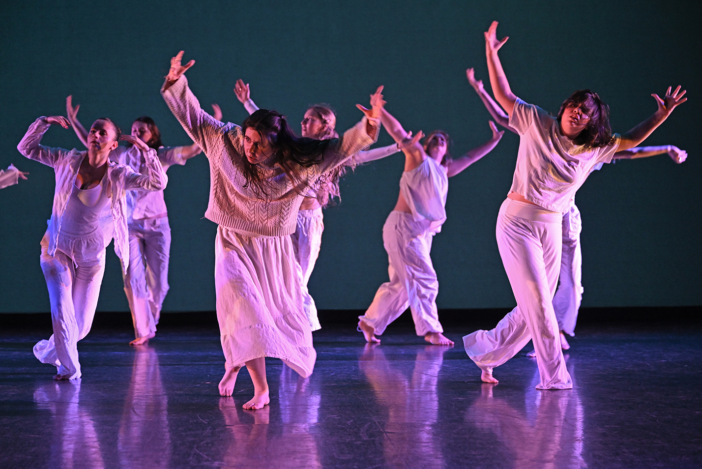 Student dancers perform modern dance in a dance studio.