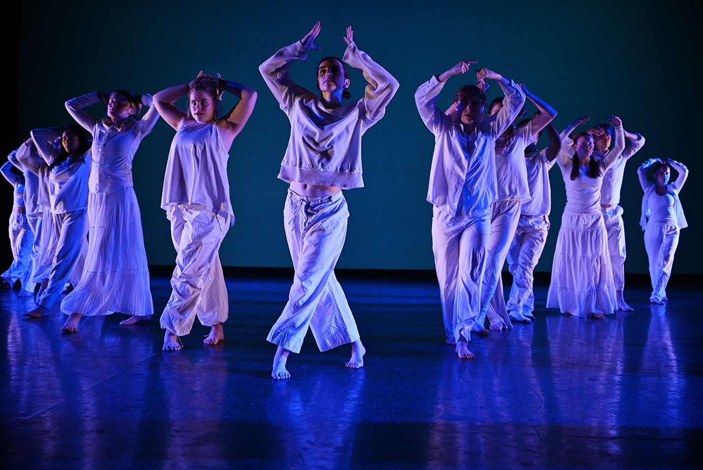 Student dancers perform modern dance in a dance studio.