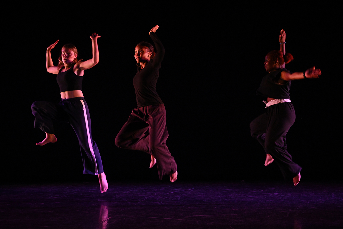 Student dancers perform modern dance in a dance studio.