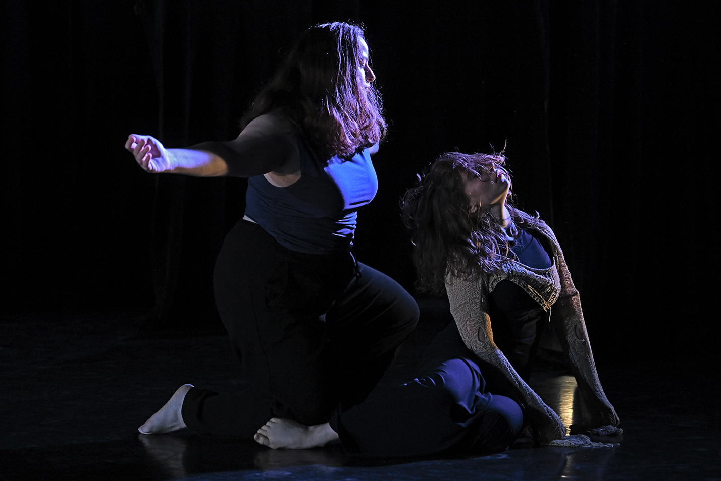 Student dancers perform modern dance in a dance studio.