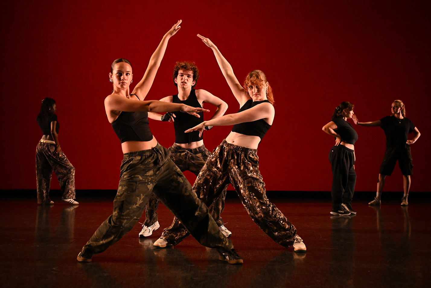 Student dancers perform modern dance in a dance studio.
