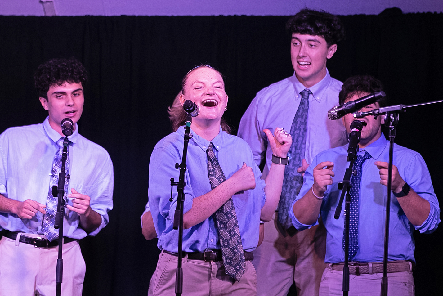 a college a cappella group performs on stage.