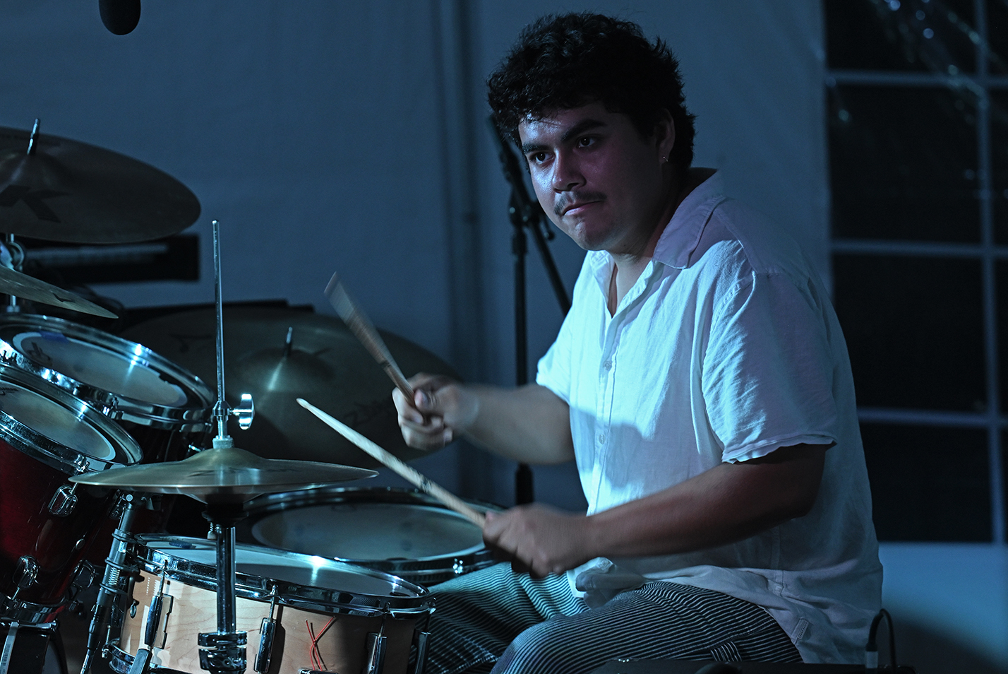 A student musician plays the drums.
