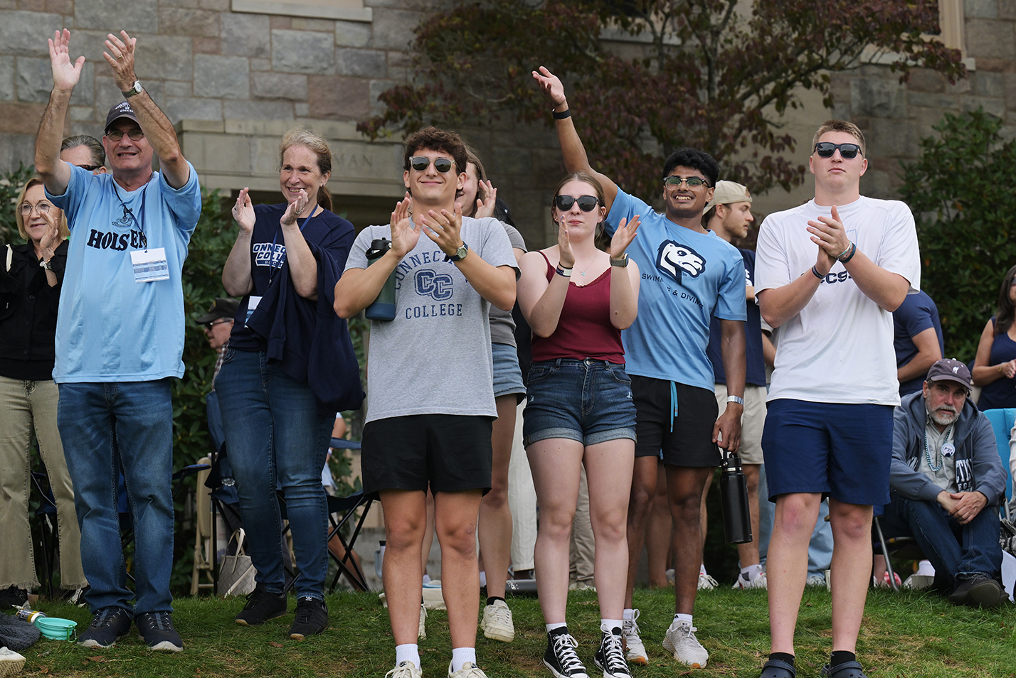 A group of college soccer fans cheer on their team.