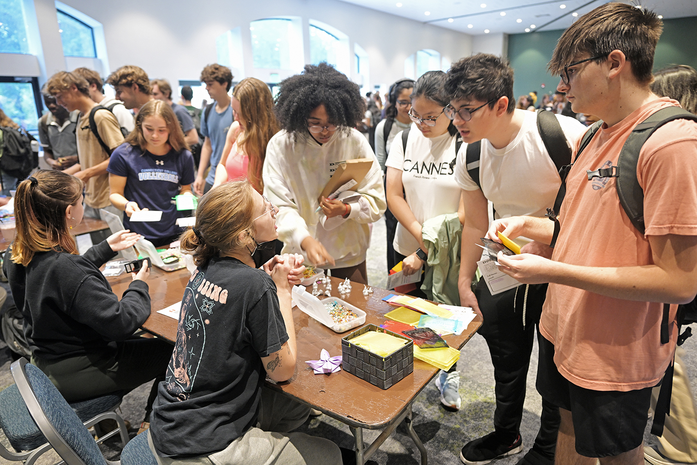 College students gather around an information table.
