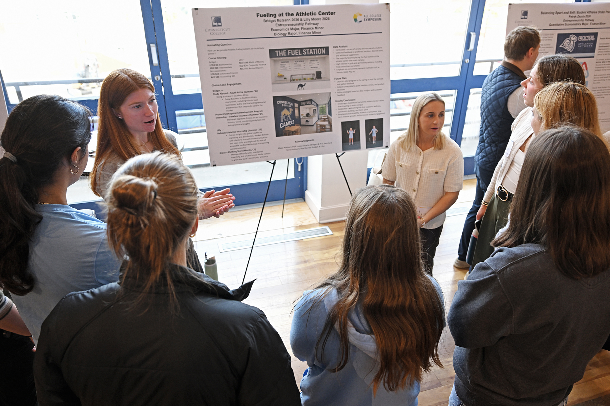 Bridget McGann '26 and Lilly Moore '26 present their poster at the All-College Symposium