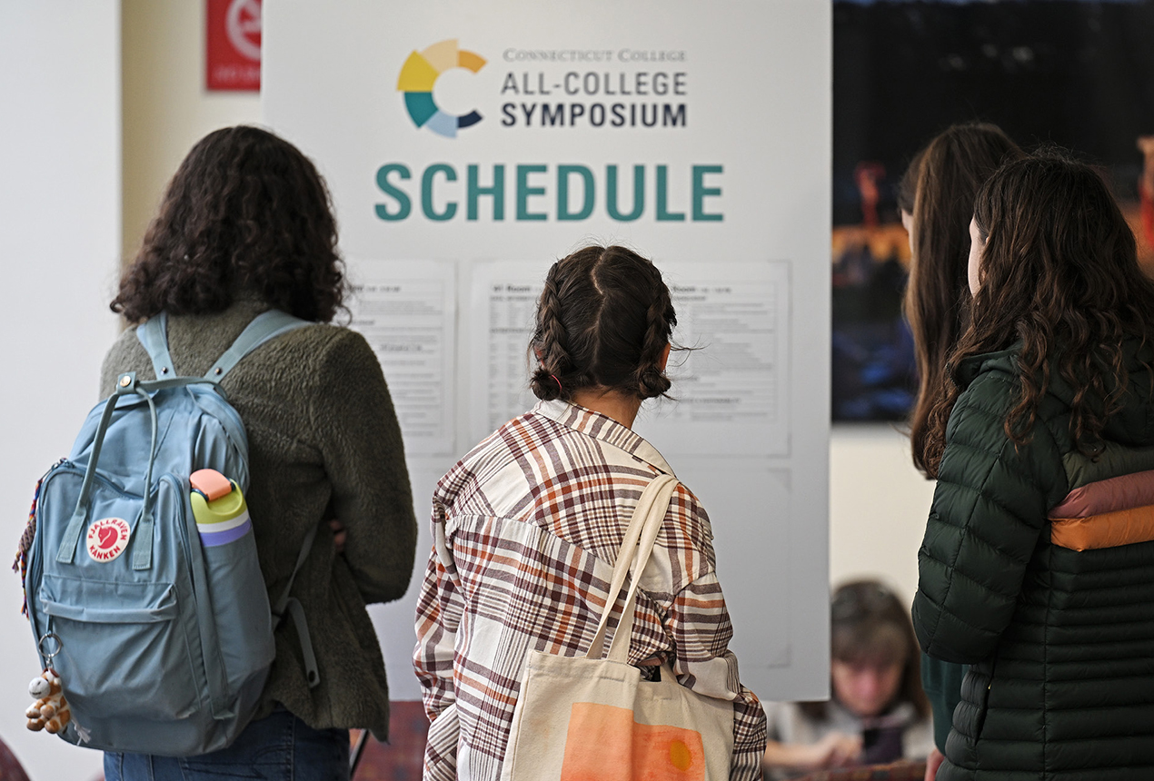 Students check out the schedule for the All-College Symposium